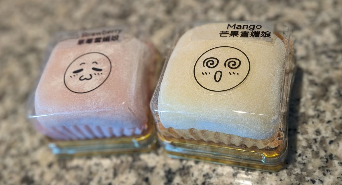 Strawberry and Mango mochi with emoji on the packages.